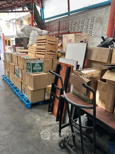 Warehouse storage area with stacked boxes and crates on pallets