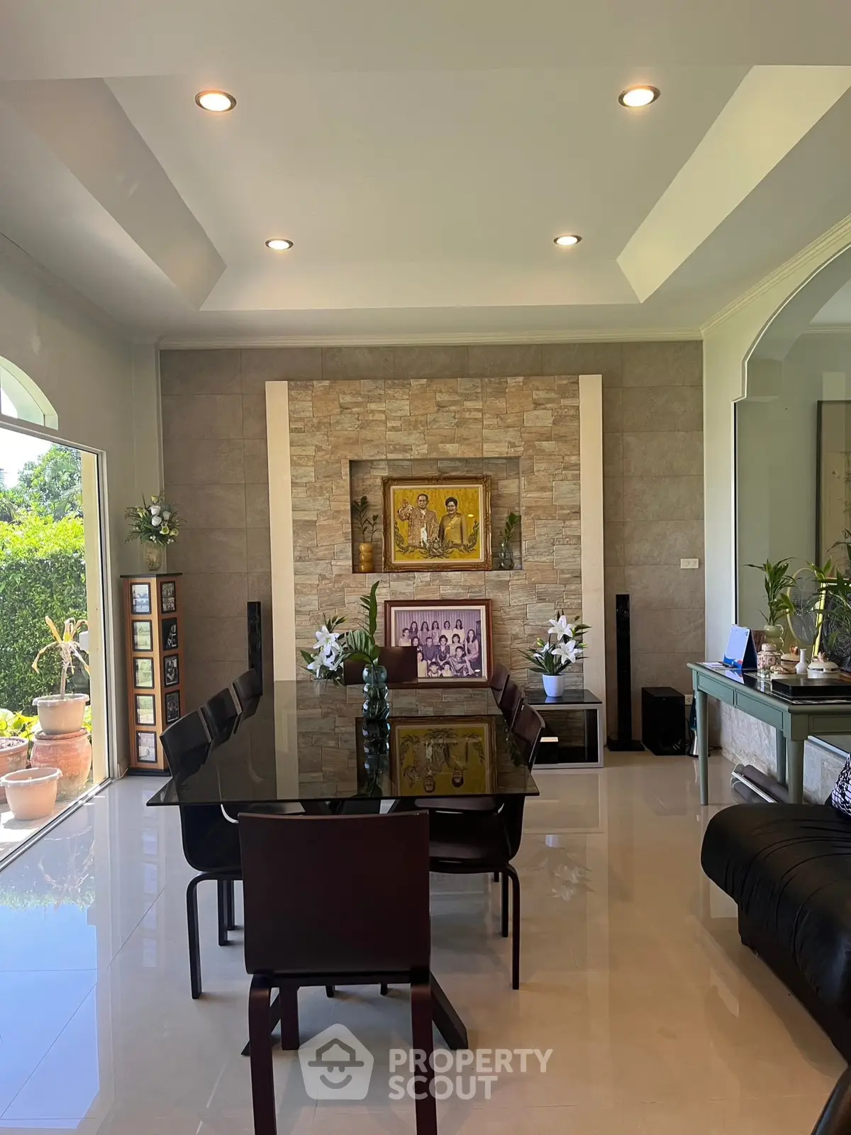 Elegant dining room with modern decor and large glass table, perfect for entertaining guests.