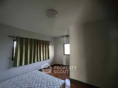 Spacious bedroom with natural light and minimalist decor