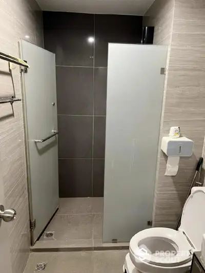 Modern bathroom with frosted glass shower and sleek fixtures