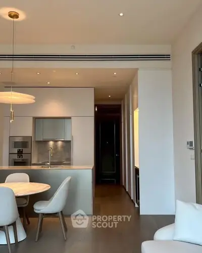 Modern open-plan kitchen with sleek design and dining area