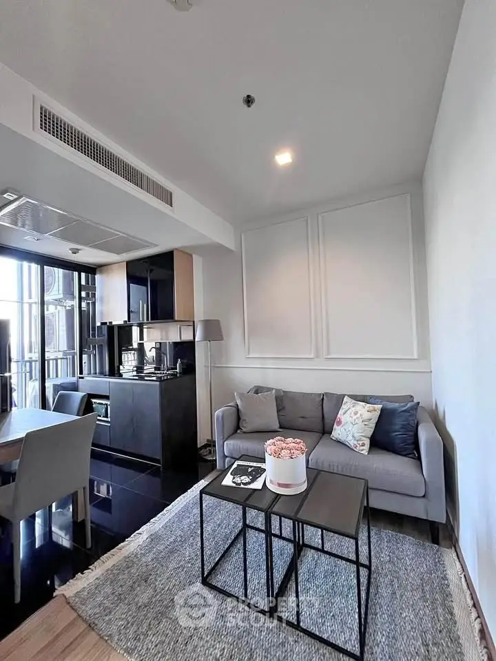 Modern living room with sleek furniture and open kitchen layout