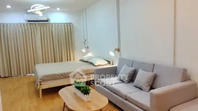 Modern studio apartment with cozy living area and stylish decor