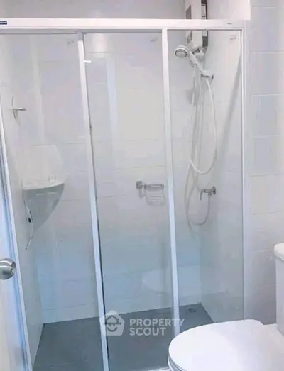 Modern bathroom with sleek shower enclosure and white tiles