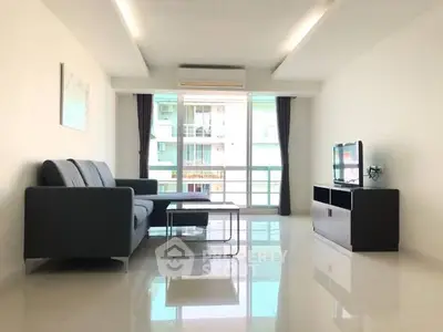 Spacious modern living room with sleek furniture and large windows for natural light.