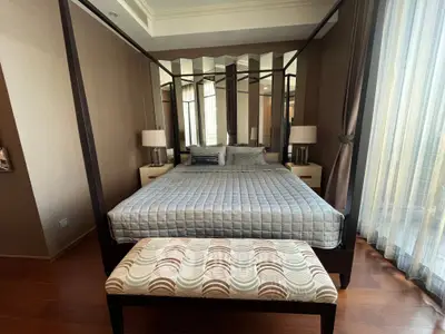 Luxurious bedroom with elegant four-poster bed and stylish decor in a high-end apartment.