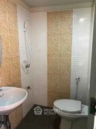 Compact bathroom with modern fixtures and stylish tile design