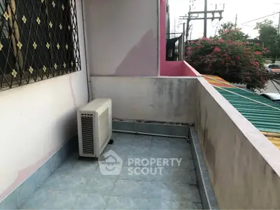 Charming balcony with tiled flooring and air conditioning unit, perfect for relaxation.