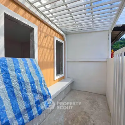 Charming outdoor space with covered patio and modern design, perfect for relaxation and leisure.