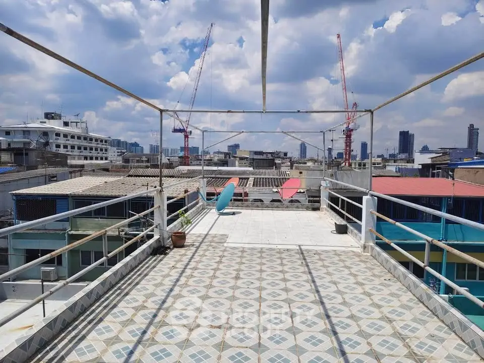Spacious rooftop terrace with city skyline views and tiled flooring, perfect for outdoor relaxation.