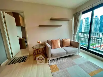 Modern living room with stylish sofa and city view balcony in high-rise apartment.