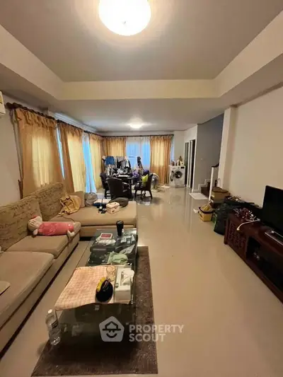 Spacious living room with modern furniture and large windows for natural light.