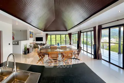 Spacious open-plan living room with panoramic windows and modern decor