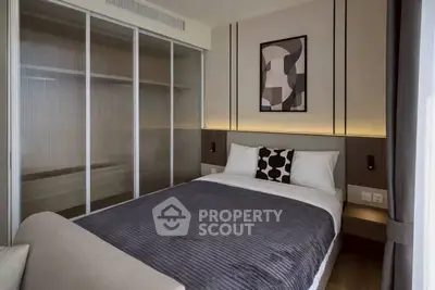 Modern bedroom with stylish decor and sliding closet doors in a contemporary apartment.