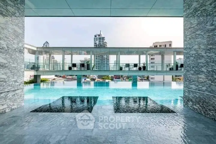Luxurious rooftop pool with stunning cityscape views in modern high-rise building.