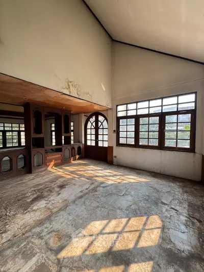 Spacious living room with large windows and natural light