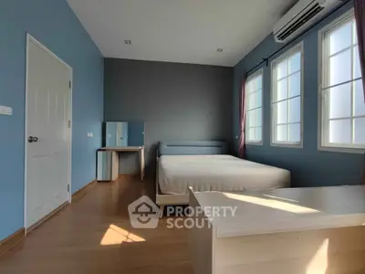Spacious bedroom with modern furnishings and natural light