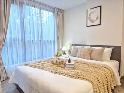 Cozy and elegant bedroom with large window and stylish decor