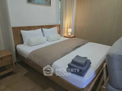 Cozy bedroom with modern wooden furniture and soft lighting, perfect for relaxation.