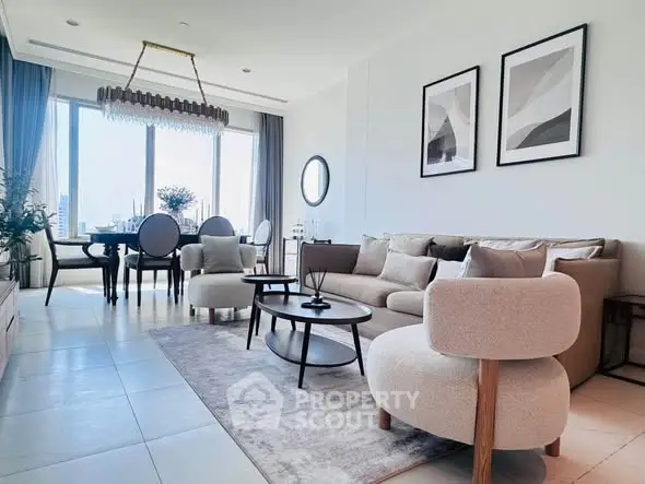Elegant living room with modern furniture and large windows offering a stunning city view.