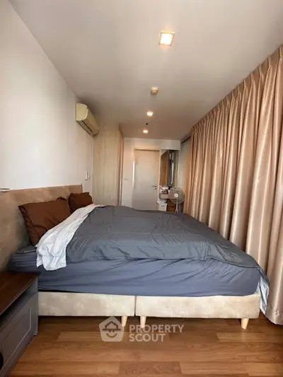 Spacious bedroom with modern decor and ample natural light