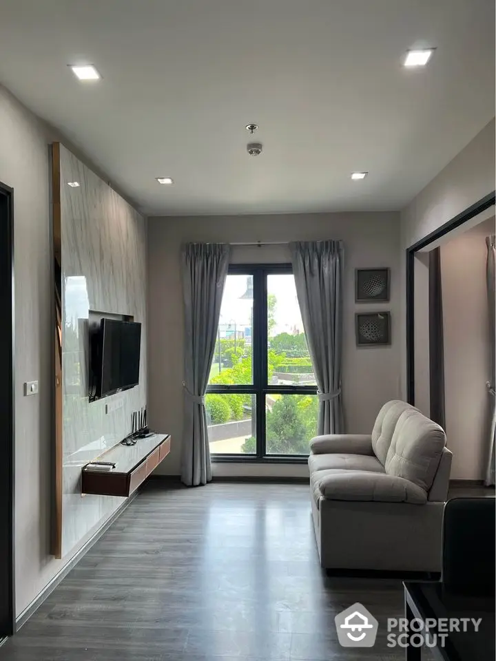 Modern living room with large window and stylish decor in a contemporary apartment.