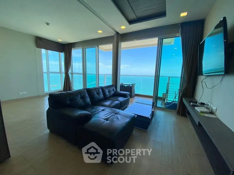 Luxurious living room with stunning ocean view and modern furnishings.