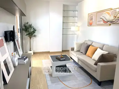 Modern living room with stylish decor, cozy sofa, and elegant shelving, perfect for relaxation and entertainment.