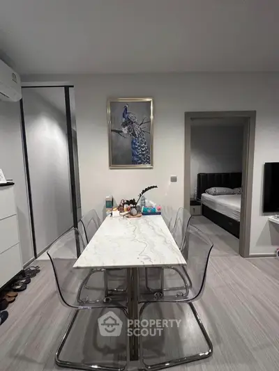 Modern dining area with marble table and transparent chairs in stylish apartment