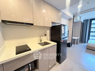 Modern kitchen with sleek cabinetry and integrated appliances in a stylish apartment.