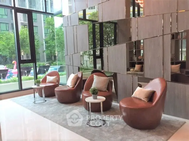 Stylish modern lobby with chic seating and large windows overlooking greenery.
