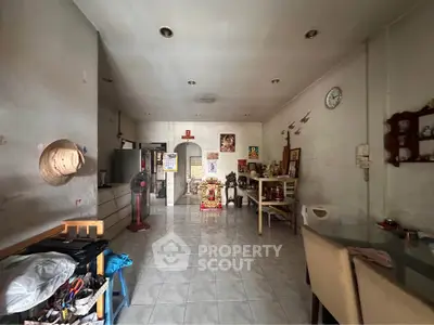 Spacious living area with tiled flooring and eclectic decor, ideal for creative interior design.