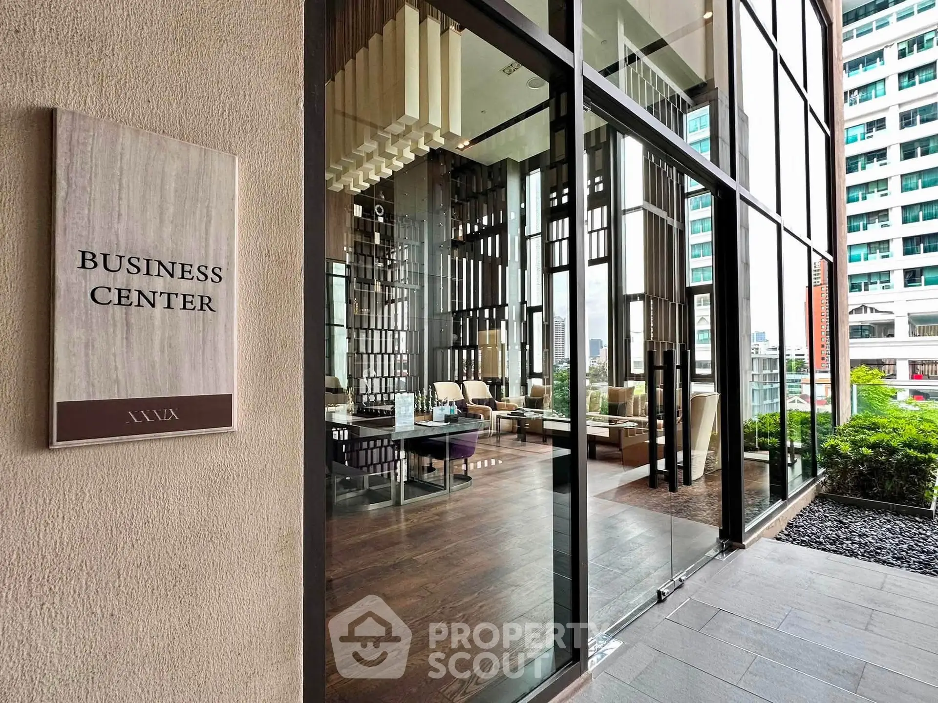 Modern business center entrance with glass facade and stylish interior design.