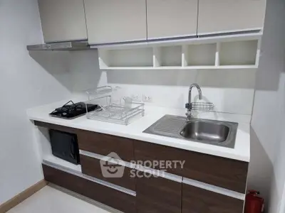 Modern kitchen with sleek cabinetry and built-in appliances in a contemporary apartment.
