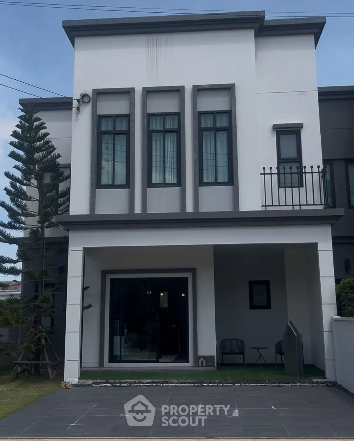 Modern two-story house with sleek facade and small balcony
