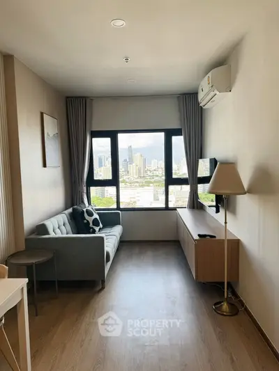 Modern living room with city view, featuring a cozy sofa and sleek furniture in a high-rise apartment.