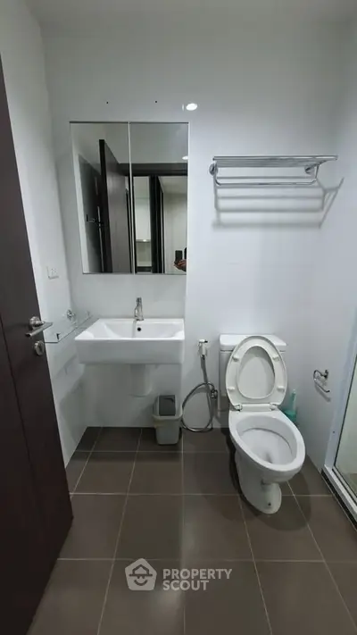 Modern bathroom with sleek fixtures and neutral tiles, perfect for a contemporary home.