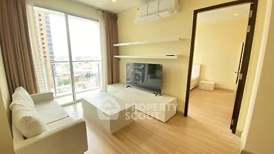 Modern living room with sleek furniture and city view from balcony in high-rise apartment.