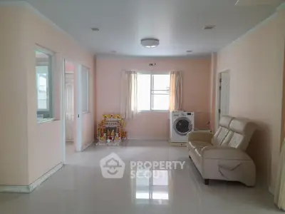 Spacious living room with modern decor and washing machine