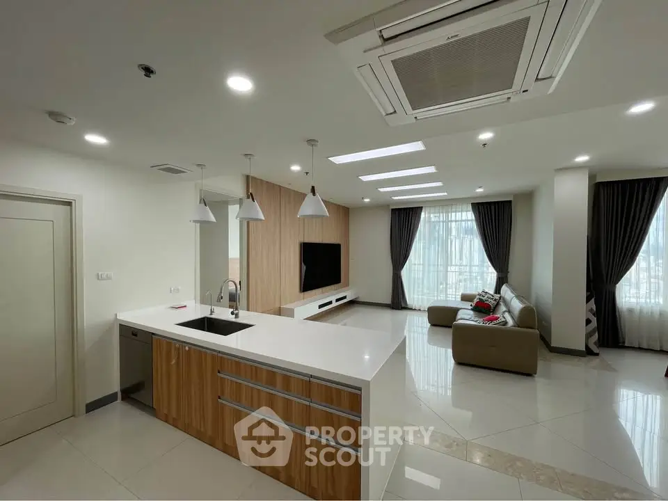 Spacious modern living room with open kitchen and stylish decor