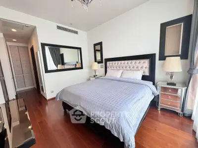 Luxurious bedroom with elegant decor and hardwood floors in a modern apartment.