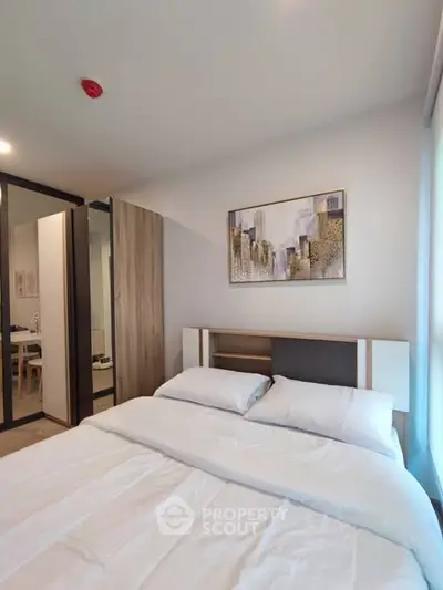 Modern bedroom with stylish decor and cozy ambiance in a contemporary apartment.