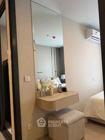 Modern bedroom with stylish vanity and comfortable bed in a cozy apartment.