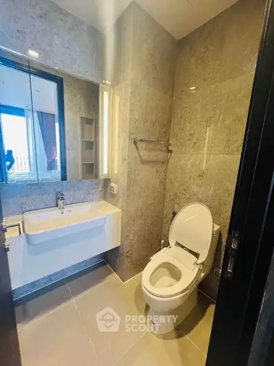 Modern bathroom with sleek fixtures and elegant tile design, offering a luxurious and contemporary feel.