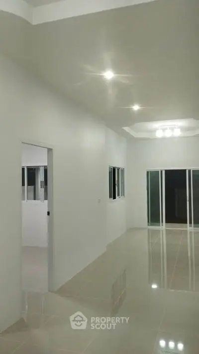 Spacious modern interior with glossy tiled floors and recessed lighting