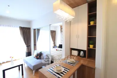 Modern studio apartment with stylish decor and open layout, featuring a cozy living area and elegant dining space.
