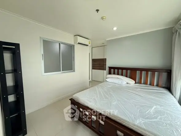 Spacious bedroom with modern furnishings and natural light