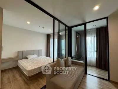 Modern bedroom with glass partition and cozy sofa in a stylish apartment.