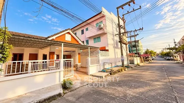 Charming suburban house with spacious front porch and vibrant neighborhood view.