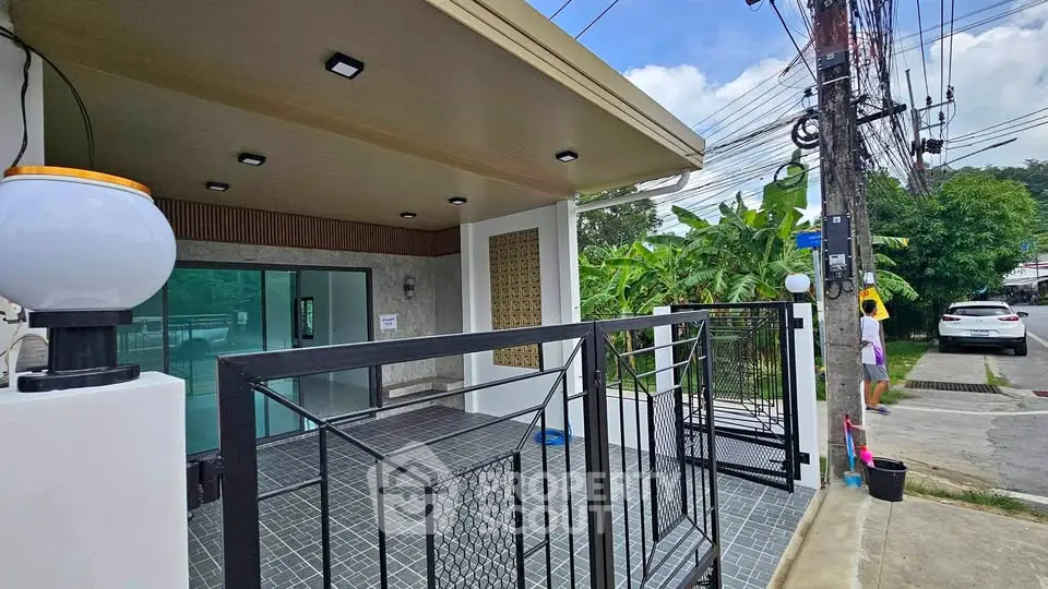 Modern house exterior with sleek design and spacious driveway in a suburban neighborhood.